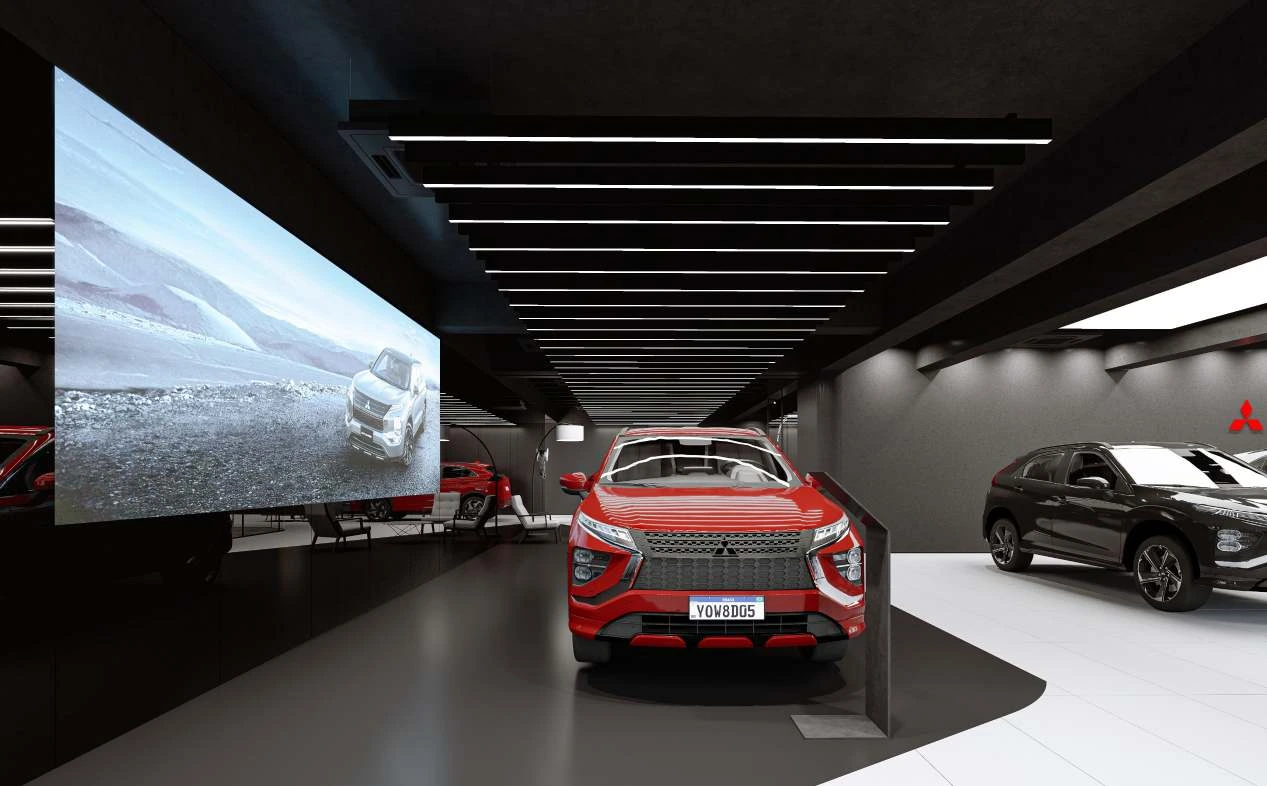 Interior Mitsubishi display wall render with linear ceiling lights and a red vehicle.