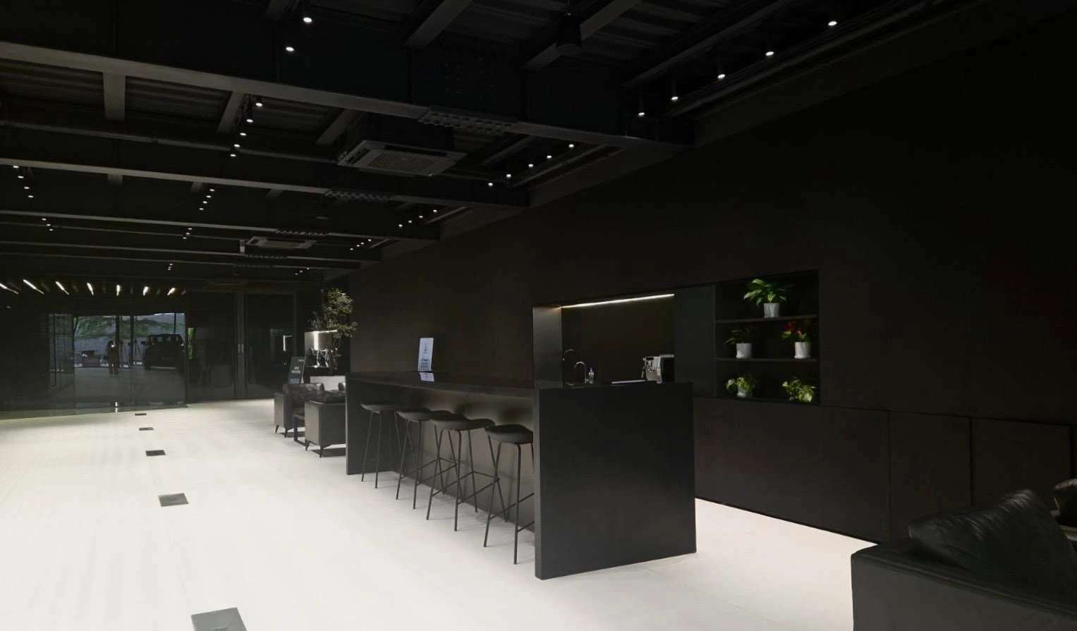 Photograph of the black showroom reception and refreshment counter.